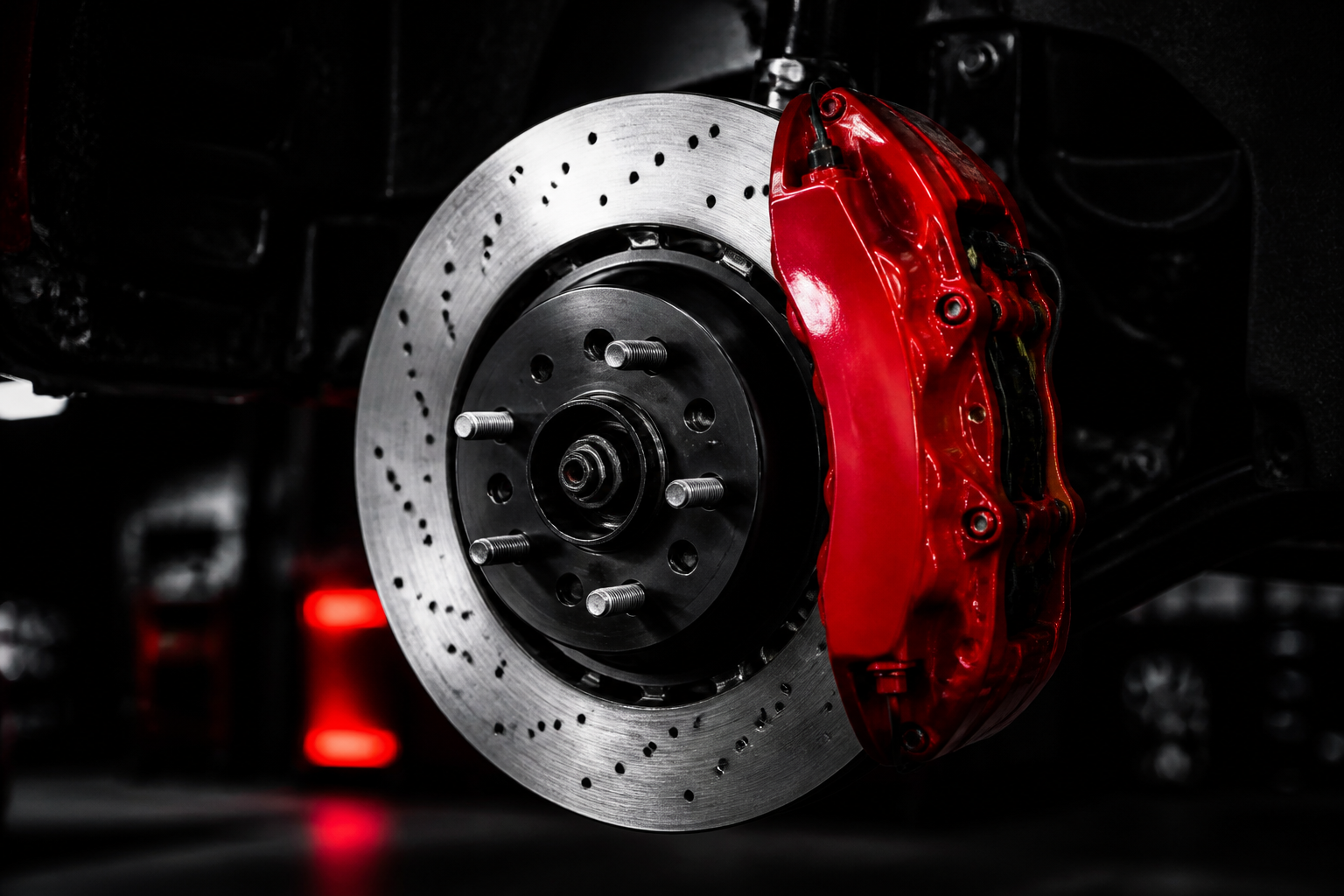 New brake rotor and red caliper installed on a vehicle
